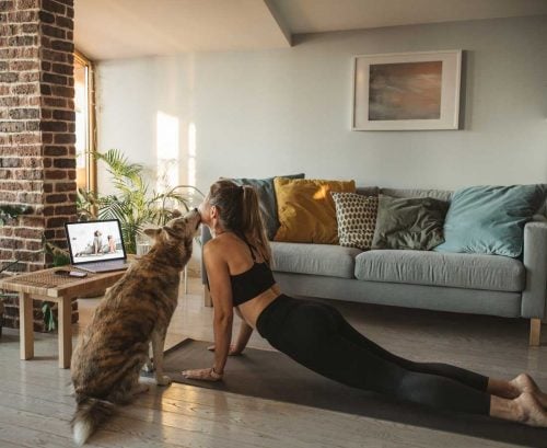 Woman doing yoga with dog