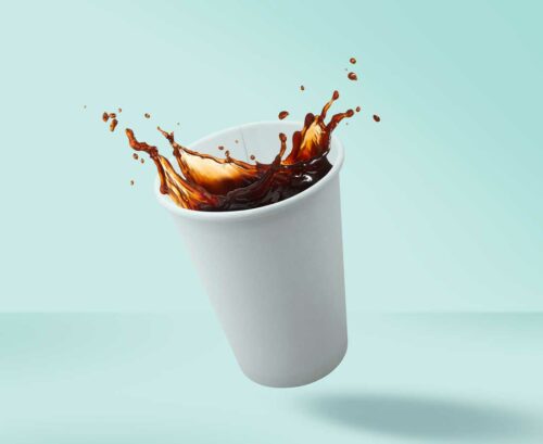 cup of coffee against a pastel blue background