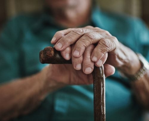 Older man with a walking stick