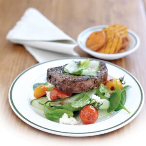 Grilled fillet steak with charred tomato and feta salad