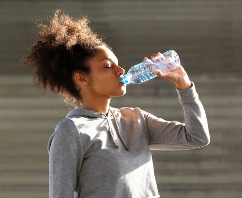 Woman drinking water out of a bottle