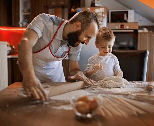 Father and son baking bread