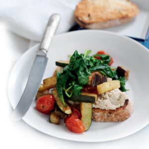 White bean mash with wilted spinach, courgette and tomato